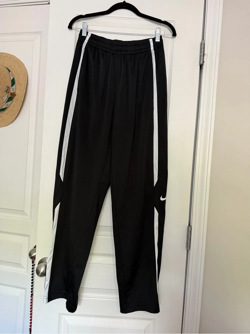 Nike black men’s track pants with white side stripes, size M